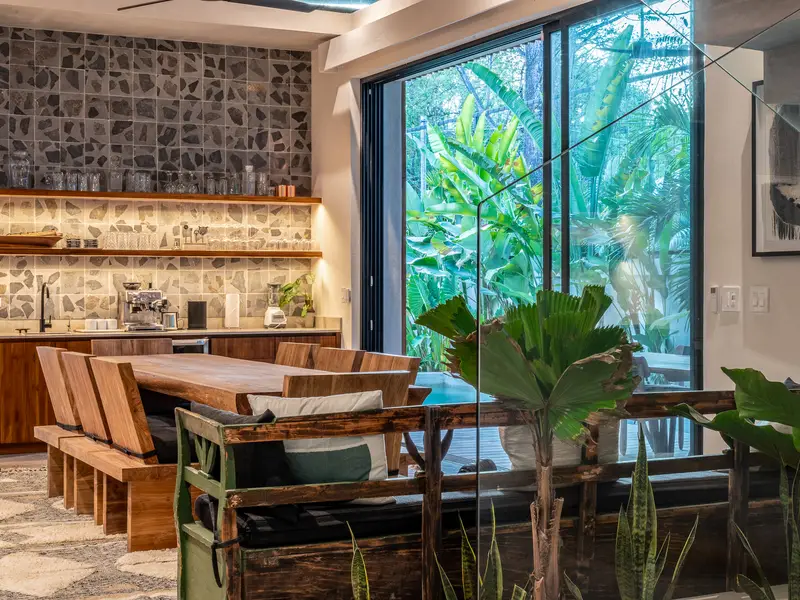 Breakfast banquette against the stone wall at Kirana Nosara
