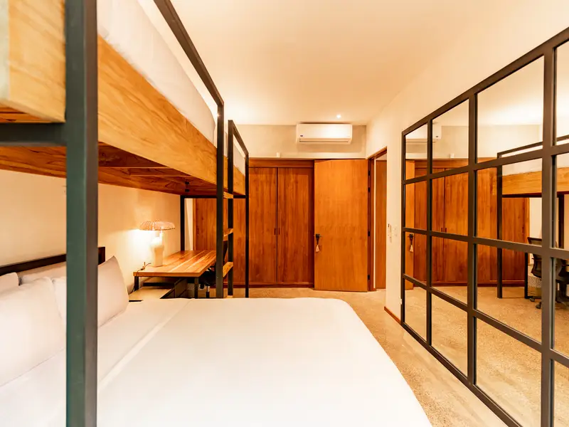 Fourth bedroom with queen bed, bunks, and teak wardrobe