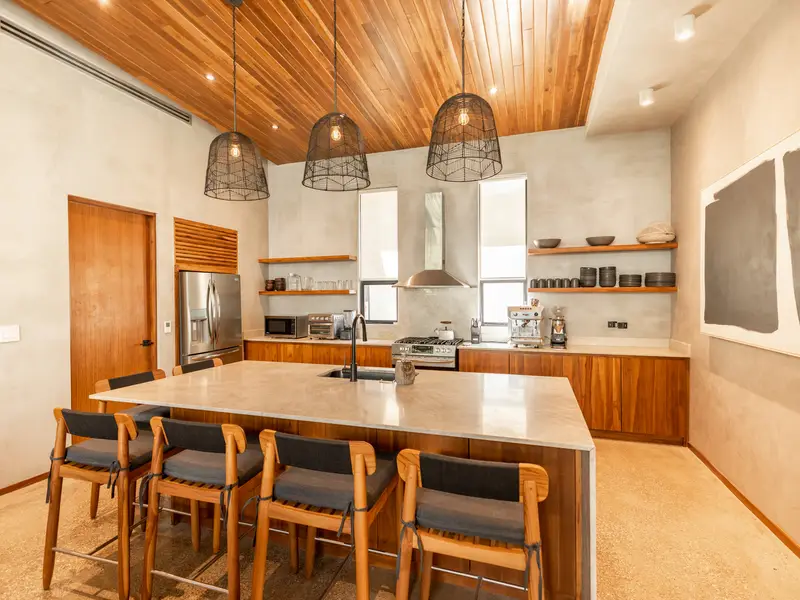 Chef's kitchen with oversized stone island, bar seating, and pro appliances