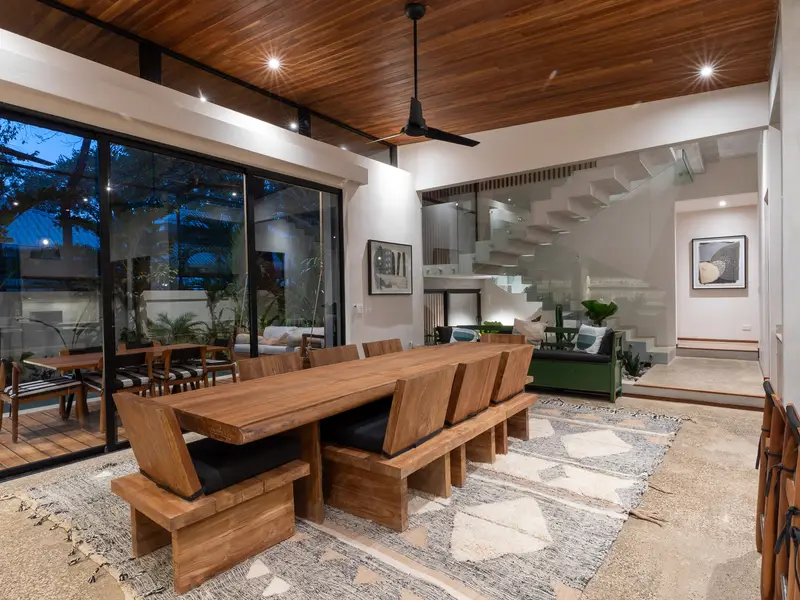 Dining room at night with warm wood ceiling and ceiling fans