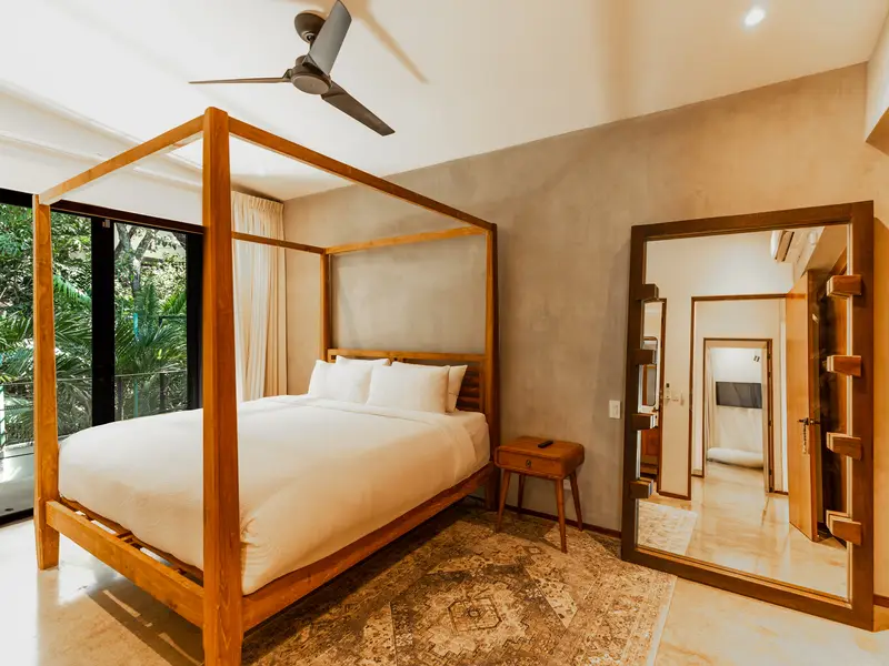 Four-poster king bed in teak with floor mirror