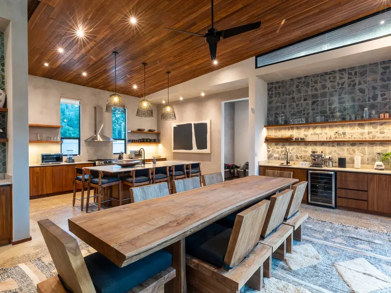 Great room with full-wall coffee and wine bar beyond the dining table