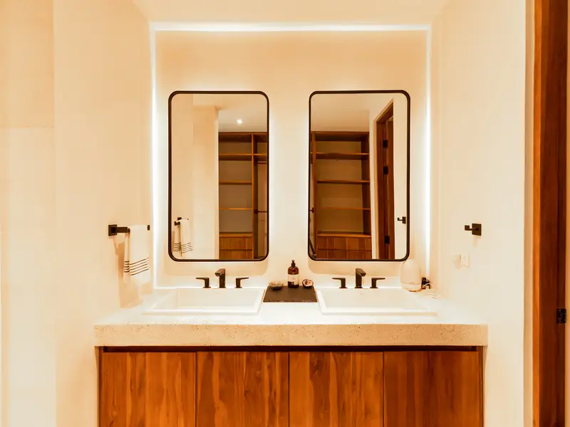 Guest bathroom with twin sinks and framed mirrors