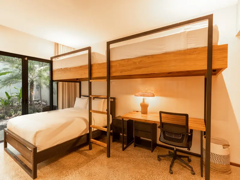 Kids' bunk room with twin-over-full bunks and built-in desk