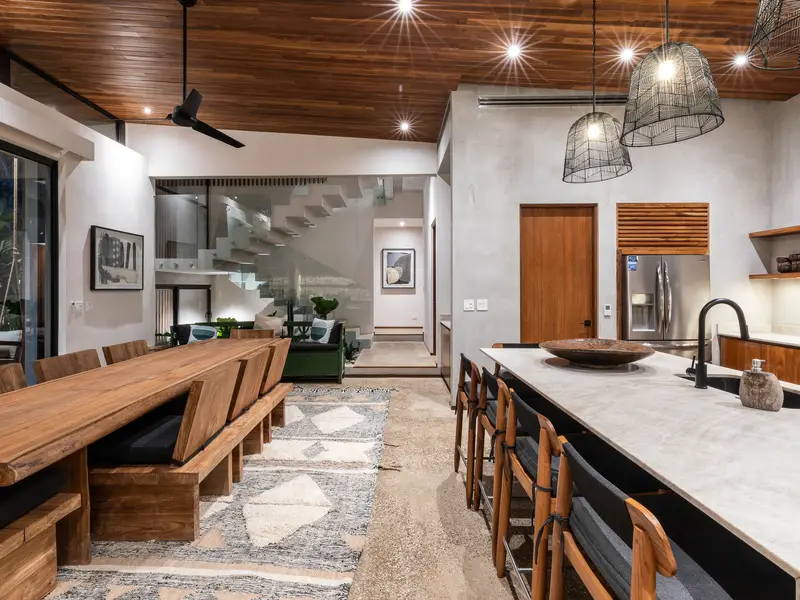 Kitchen island and dining room glowing in the evening