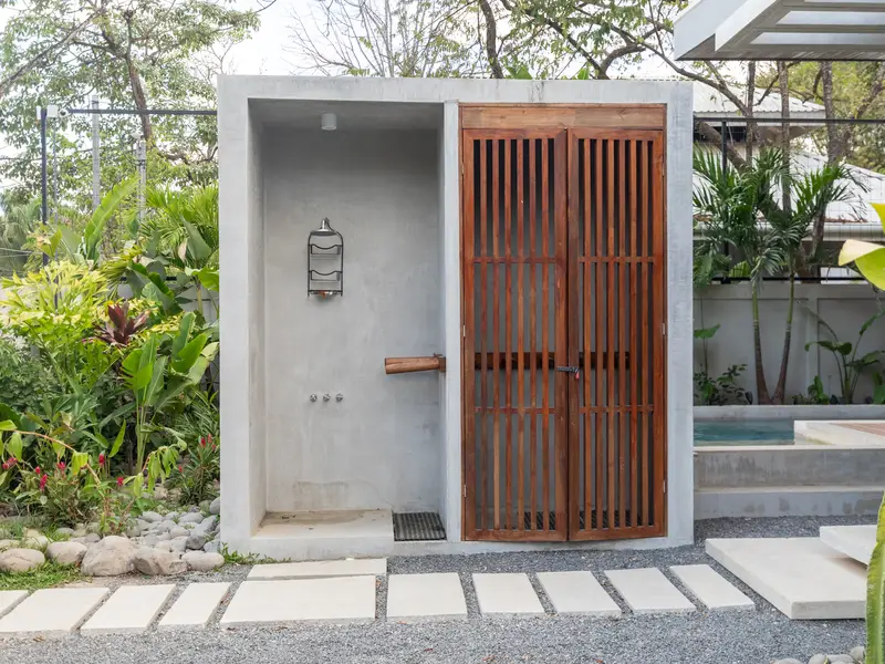 Outdoor rain shower beside the pool for post-surf rinses
