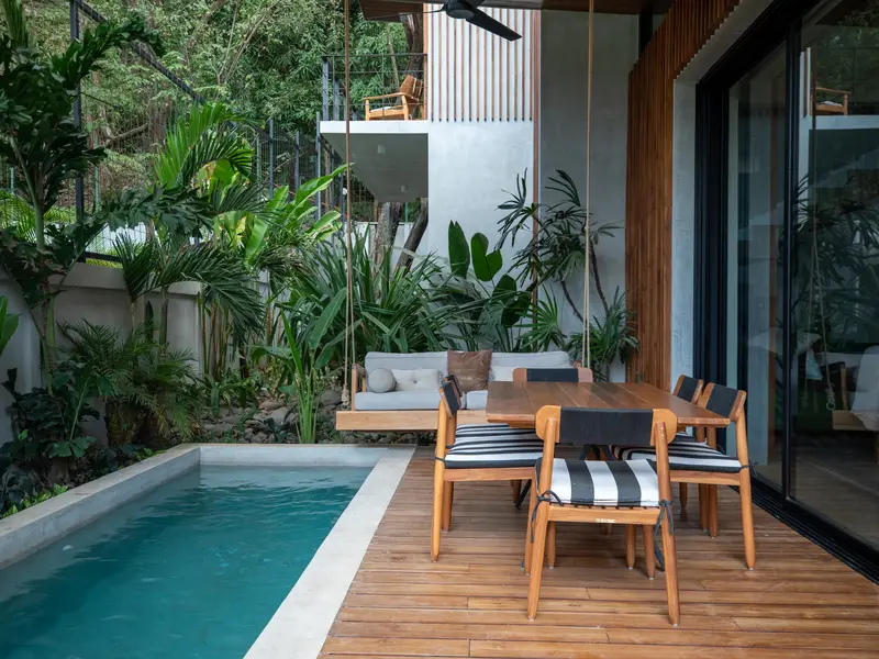 Kirana Nosara's pool, swing daybed, and outdoor dining terrace