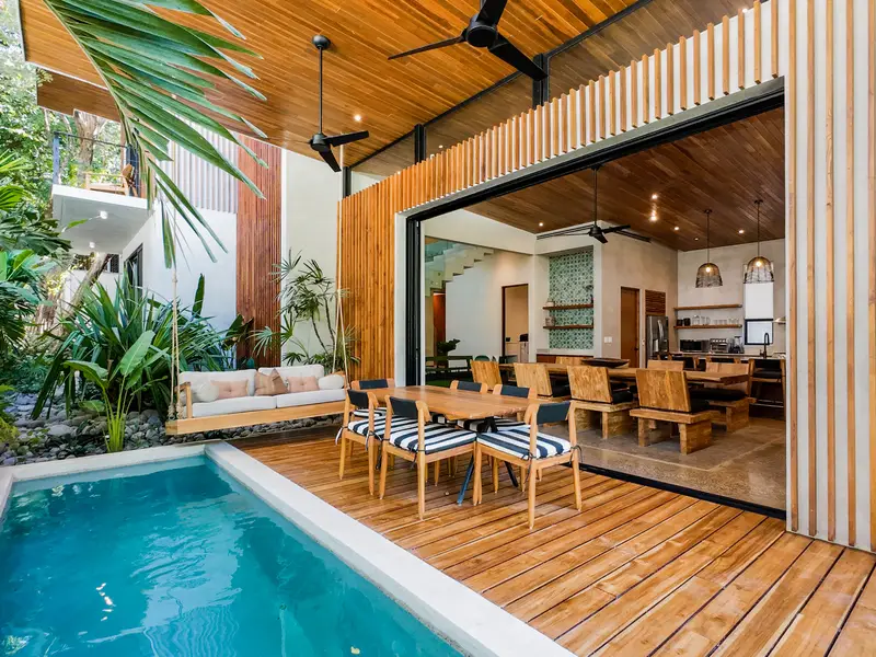 Wide view of the pool with the great room opened up behind it