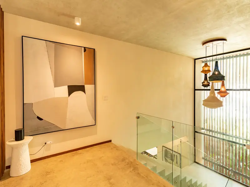 Upstairs landing with gallery art and pendant cluster